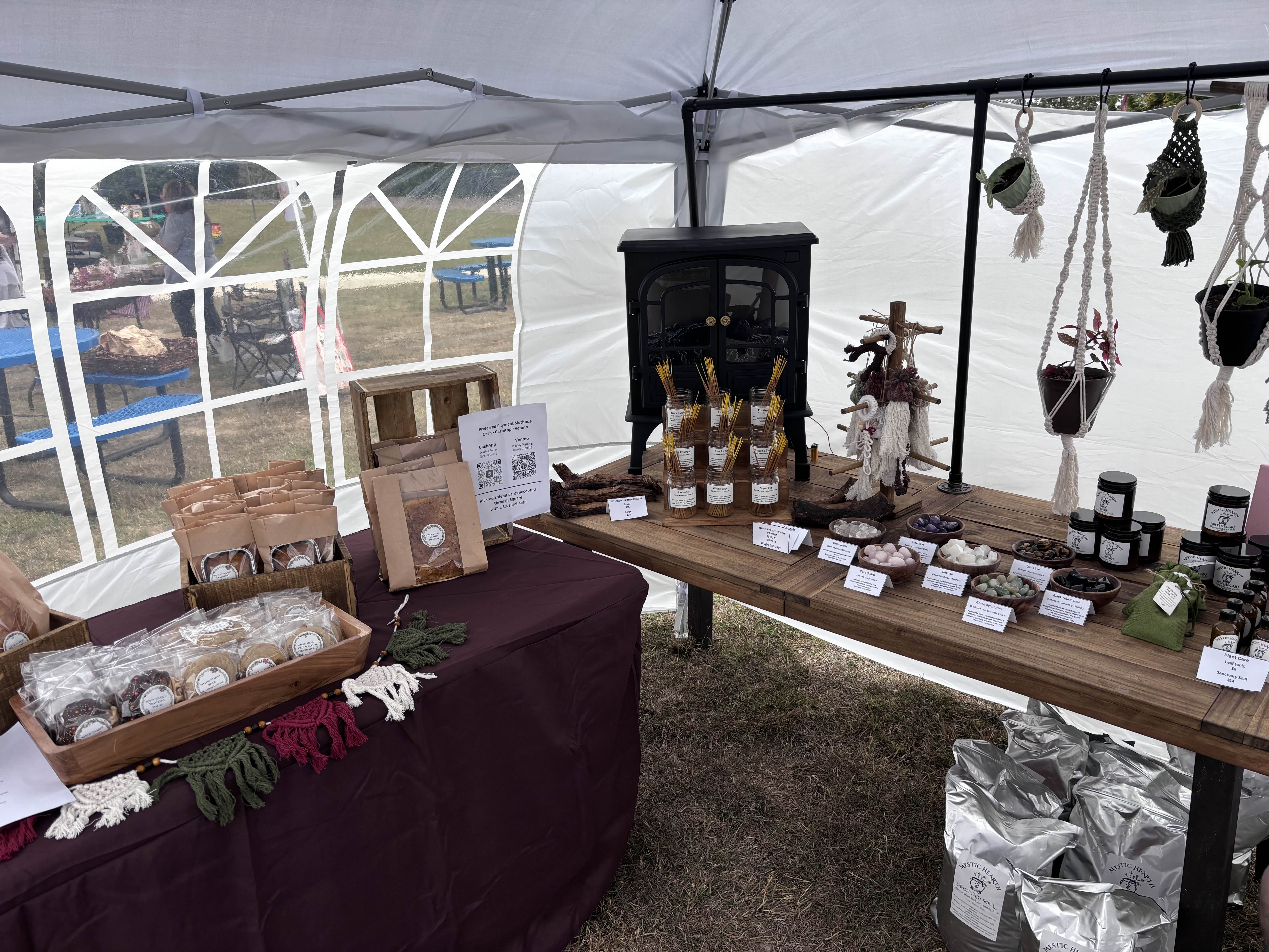 Mystic Hearth sign and makers at the booth